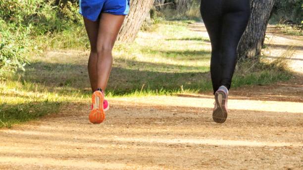 istock girls are jogging in the park 854091542