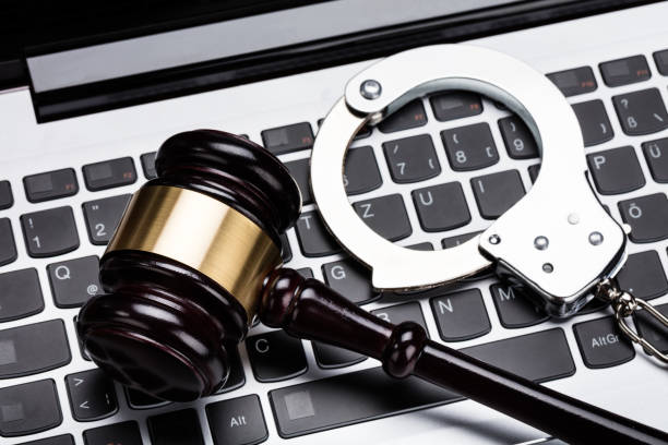 istock Gavel And Handcuff On Laptop Keyboard 854093712