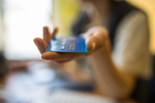 Chicago-April 23,2017:Woman’s hand holding a Visa credit card (for editorial use only)