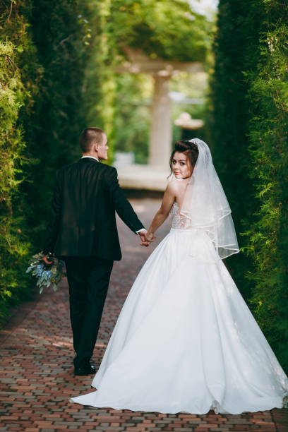istock Beautiful wedding couple on a walk outdoor 854103228
