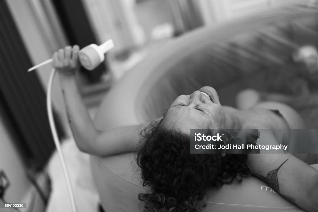 Home Birth Woman during childbirth at home Labor - Childbirth Stock Photo