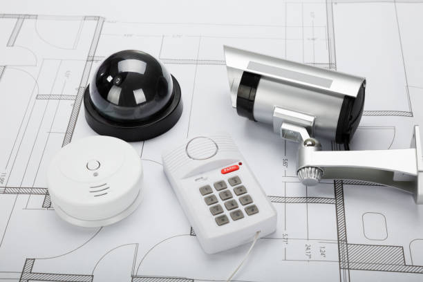 Security Equipment With Blueprint High Angle View Of Security Equipment On Blueprint In Office fire alarm photos stock pictures, royalty-free photos & images