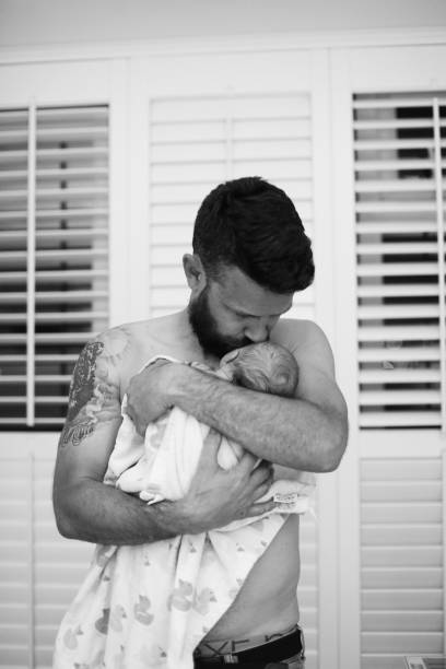 Home Birth Father holds his newborn baby for first time. water birth stock pictures, royalty-free photos & images