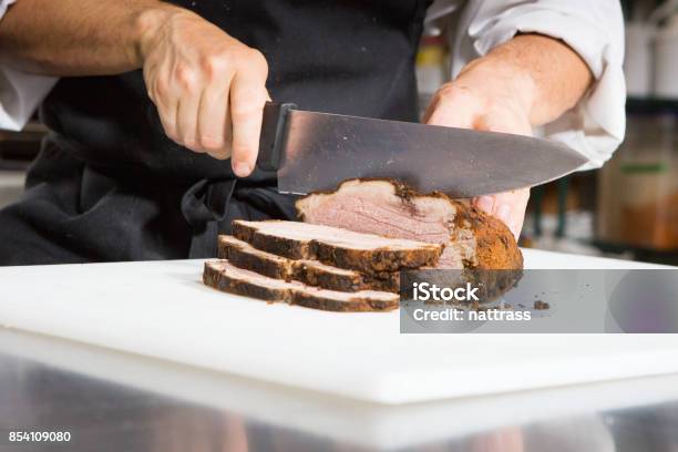 Chef Slicing Roast Beef Using Carving Knife Stock Photo - Download