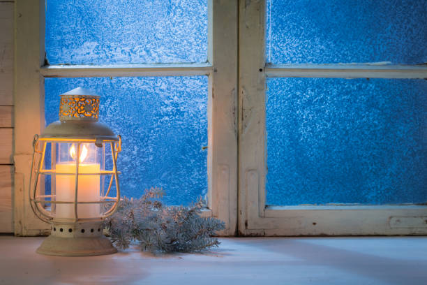 istock Blue window at night with burning candle for Christmas 854109450
