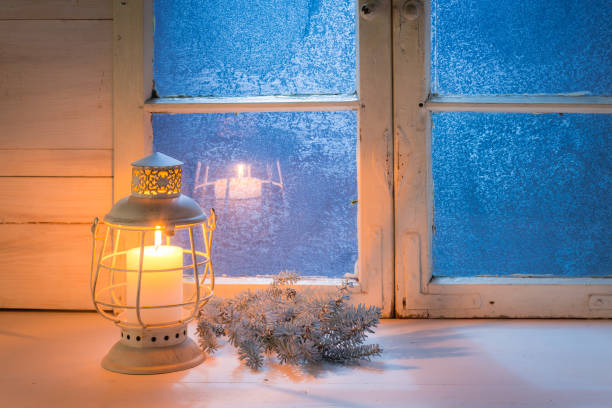 istock Blue window at night and burning candle for Christmas 854109824