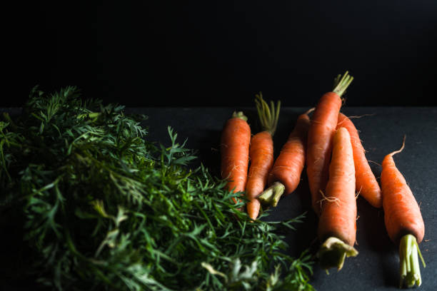 istock Cut from the carrot tops side view 854110132