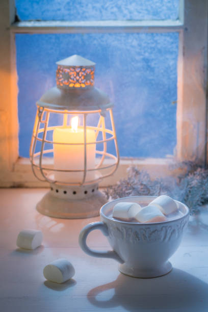 istock Christmas chocolate with marshmallows in cold evening by blue window 854111462