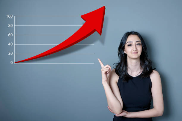 istock Business woman showing line graph on the board 854114992