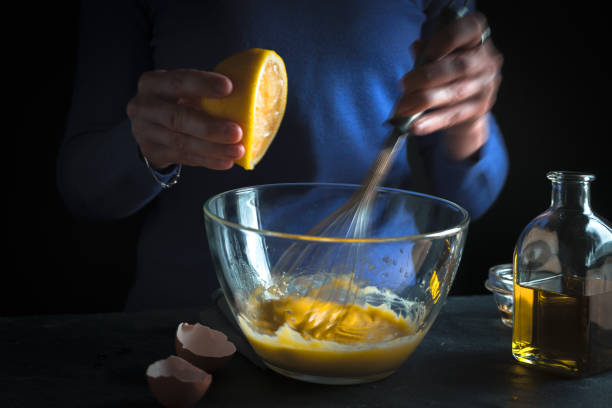 istock Lemon is squeezed into a bowl with yolks and mustard close-up 854115804