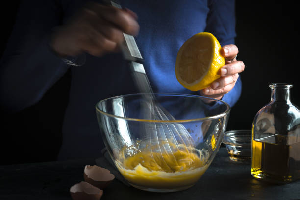 istock Whipping yolk with mustard and squeezing lemon juice 854118004