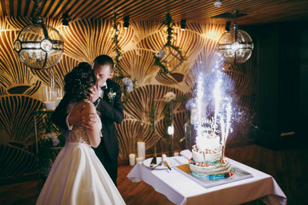 istock Wedding couple kissing on wedding cake background 854120434