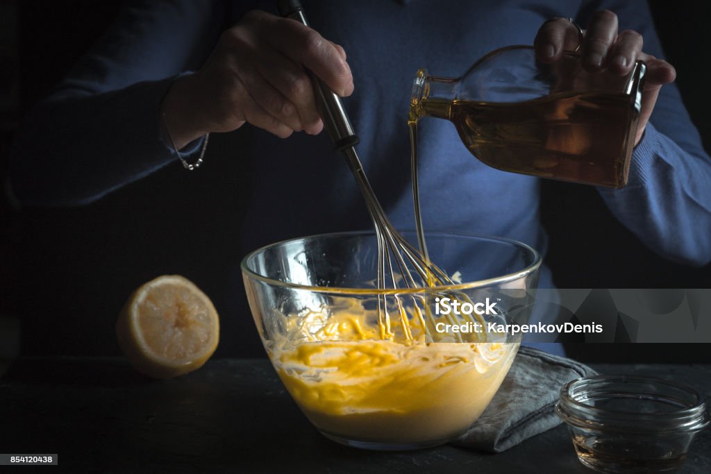 Beat egg yolks with mustard and olive oil Beat egg yolks with mustard and olive oil horizontal Mayonnaise Stock Photo