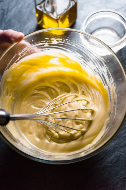 istock Beat egg yolks with mustard and olive oil close-up 854120556