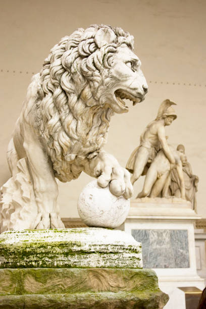 istock Lion Statue with Palazzo Vecchio in Florence, Italy 854125242