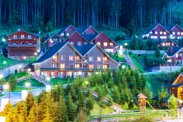 Summer view of winter ski resort Bukovel, Ukraine Scenic summer view of winter mountain ski resort with house cottages with forest and skiing slope in Bukovel, Ukraine bukovel ski resort ukraine stock pictures, royalty-free photos & images