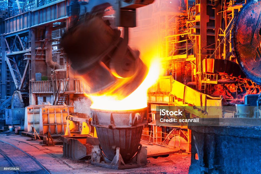 Pouring of liquid metal in open hearth workshop Pouring of liquid metal in open hearth workshop of the heavy industry metallurgical plant Blast Furnace Stock Photo
