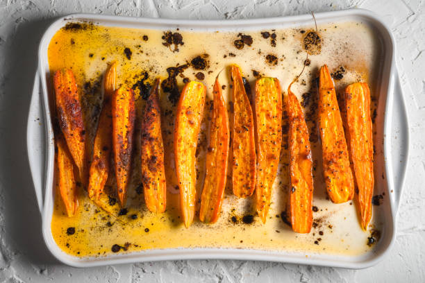 istock Stewed carrots in spices on a ceramic baking sheet top view 854130292