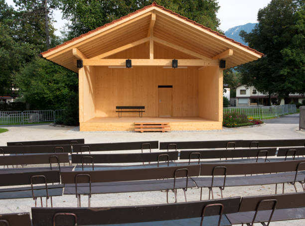istock Wooden stage with roof and empty benches 854135504