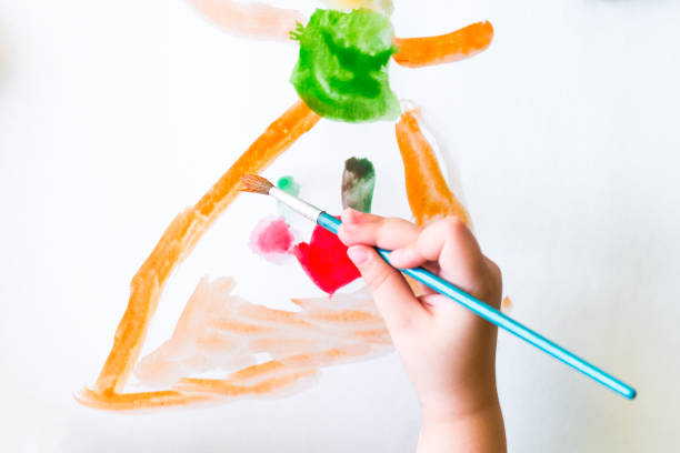 istock Kid is drawing with watercolors 854136118