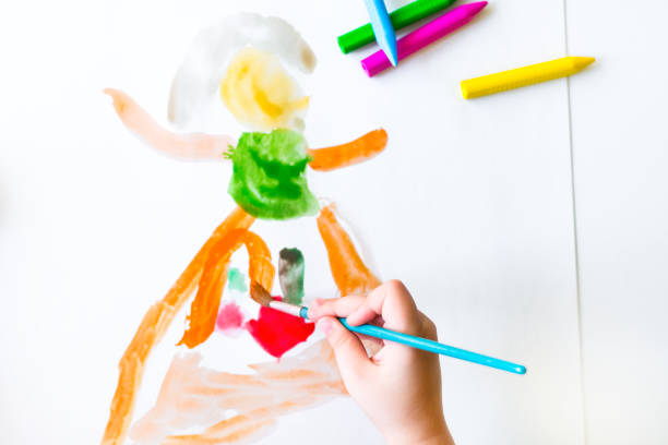 istock Kid is drawing with watercolors 854136158