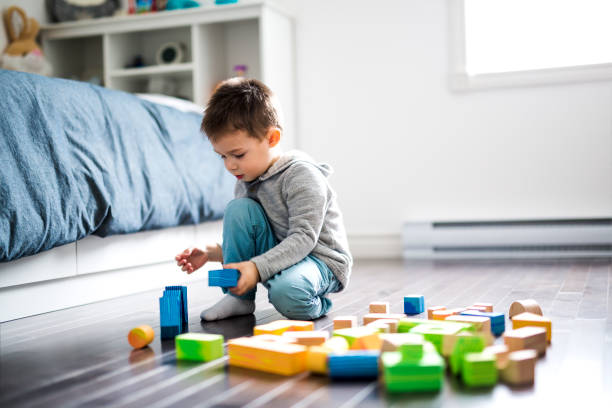 istock cute child playing with color toy indoor 854136224