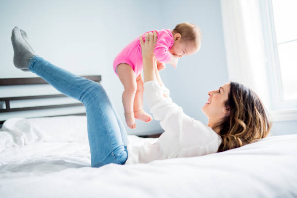 istock Mother and baby child on a white bed 854139886