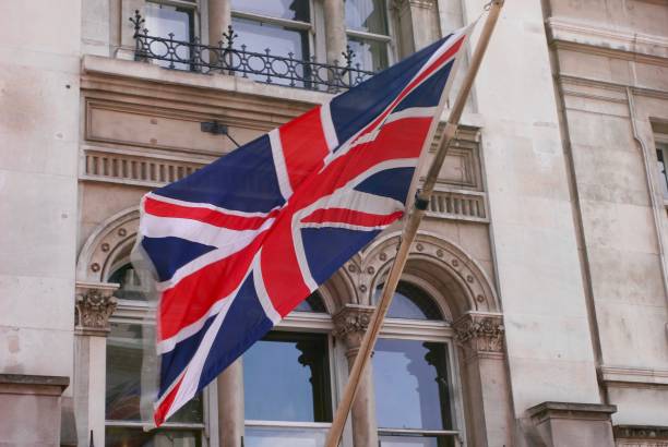 istock British flag waving outside British Building 854140048