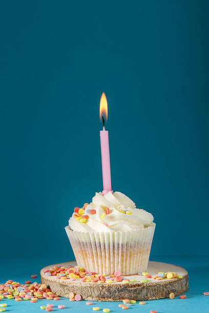 istock Capcake with a candle for a birthday. A delicious cake. Dark background. 854142808