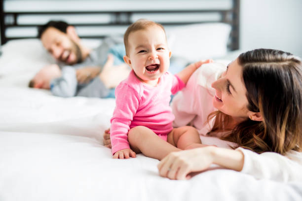 istock four peoples family on a white bed 854144114