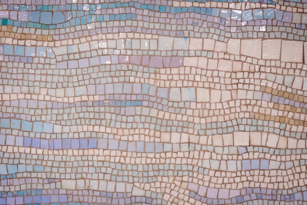 Old distressed mosaic wall background with colorful tiles.