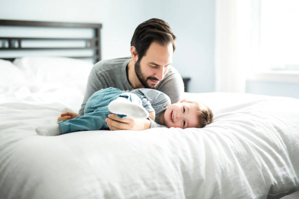 istock Father and son in bed, happy time on bed 854147450