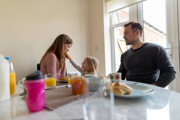 istock Parents eating breakfast with  young daughter 854161156
