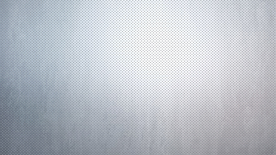 Brushed metallic texture, perforated by small circular holes