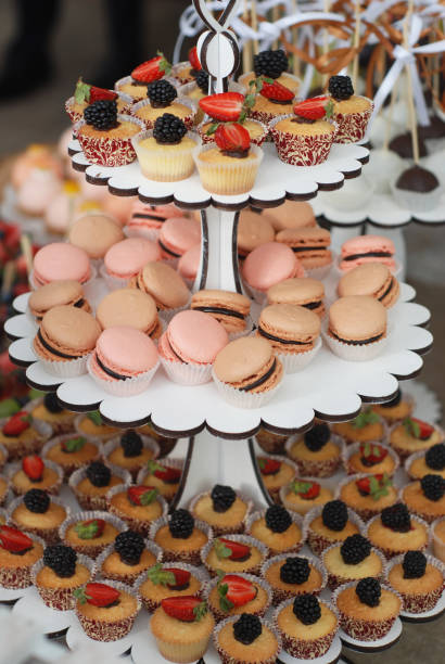 istock Delicious sweets, cupcakes, macaroons on white stand. wedding candy bar. 854169808