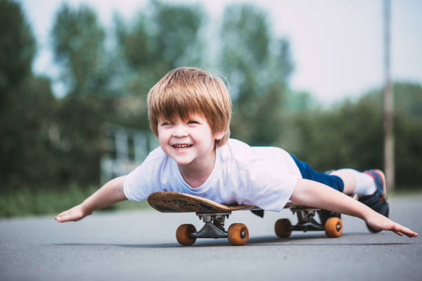 istock Smiling little boy on skateboard outdoor. 854175158
