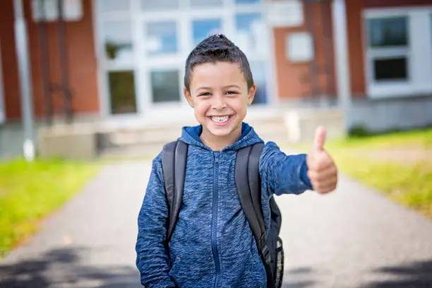 Photo of student outside school standing smiling