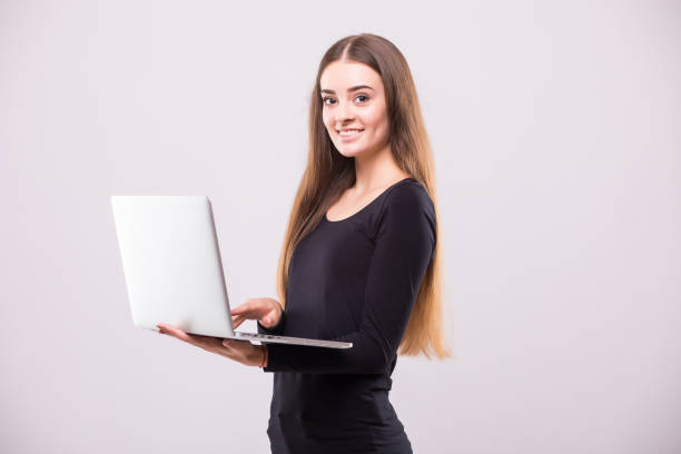 istock Brunette Woman with laptop and thumb up on white background 854183696