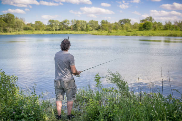 istock Man fishing on a lake 854187686