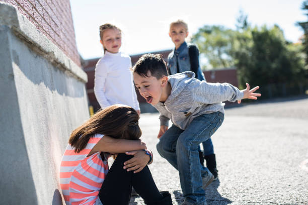 Elementary Age Bullying in Schoolyard sad moment Elementary Age Bullying in Schoolyard cruel stock pictures, royalty-free photos & images