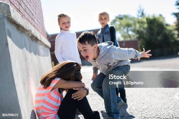 Elementary Age Bullying In Schoolyard Stock Photo - Download Image Now - Bullying, Child, Education