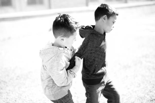 Two Boys Fighting In Playground A bad Two Boys Fighting In Playground schoolyard fight stock pictures, royalty-free photos & images