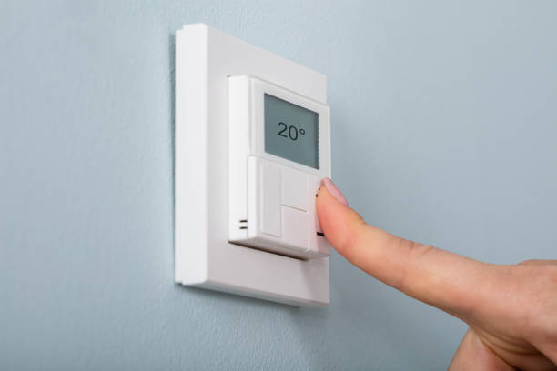istock Person Setting The Thermostat 854202826