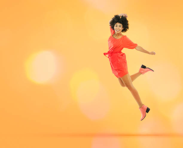 Jumping young woman in dress
