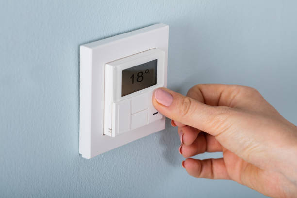 istock Person Setting The Thermostat 854205058