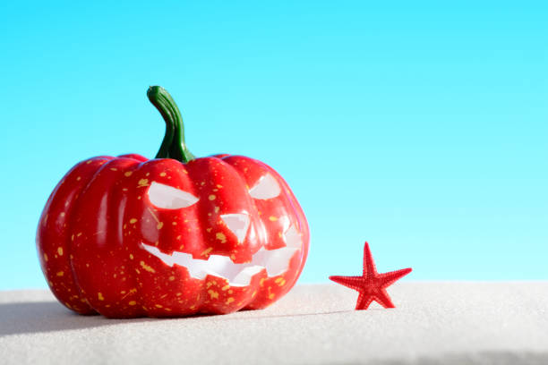 istock Creepy pumpkin on sandy beach 854205448
