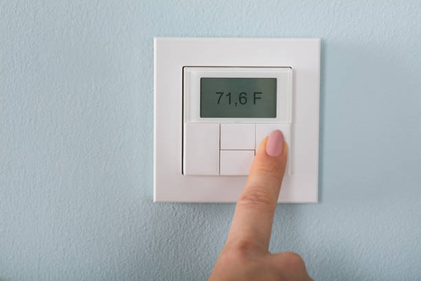 istock Person Setting The Thermostat 854205898