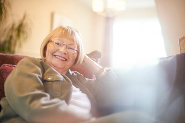 istock Senior woman relaxing at home on the sofa 854215396