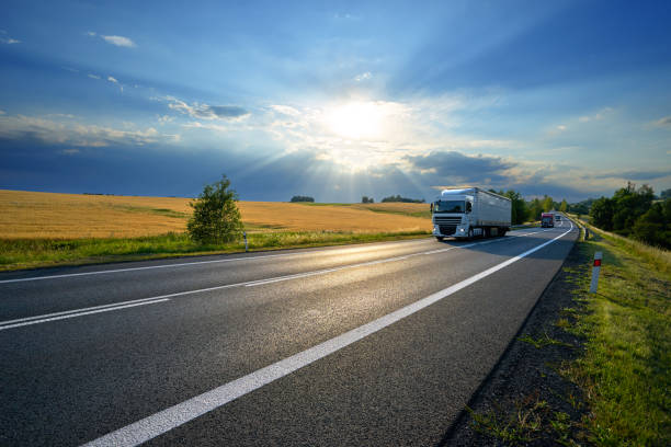 istock Trucks on the road in rural landscape at sunset 854215780