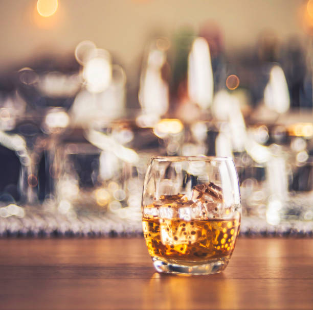 istock Glass tumbler with whisky on ice 854218694